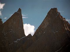20 Lobsang Spire From Khoburtse Just After Sunrise The early morning sun shines on Lobsang Spire (5707m) from Khoburtse. Lobsang Spire was first climbed on June 13, 1983 alpine style by Doug Scott, Greg Child, and Pete Thexton. �It�s featureless up there. Impossible,� says Doug. 
Out comes the drill. 
 For two hours I hammer away on the fifteenth pitch, interspersing rivets with sequences of skyhooks balanced on tiny edges, in order that our ten rivets might last the 100 ft to the summit. When I step onto the final skyhook placed on the lip of the knife-edged summit I grab a handful of snow and sprinkle it onto Pete And Doug below. �A present from the summit,� I shout.� - Thin Air: Encounters in the Himalayas by Greg Child.